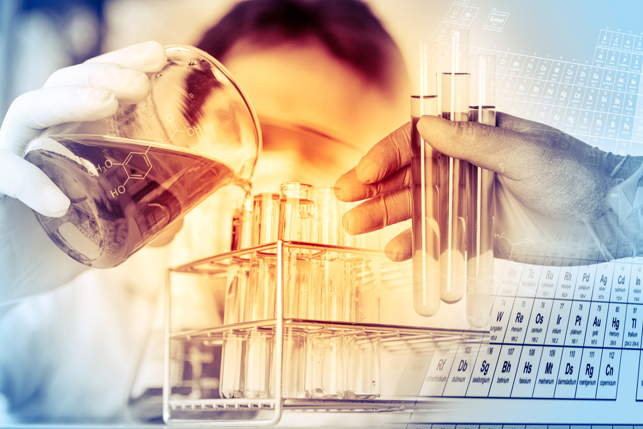 Scientist pours liquid into test tubes