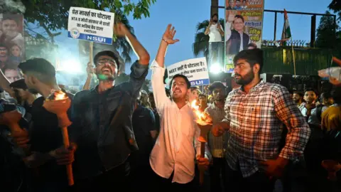 Getty Images NEW DELHI, INDIA - JUNE 15: Members of NSUI protest Mashal March organized by NSUI to protest against the alleged rigging in the NEET Exams, they demand a fair investigation and re-conduct of the examination (RENEET). at NSUI office , Raisina road, on June 15, 2024 in New Delhi, India. (Photo by Sanchit Khanna/Hindustan Times via Getty Images)